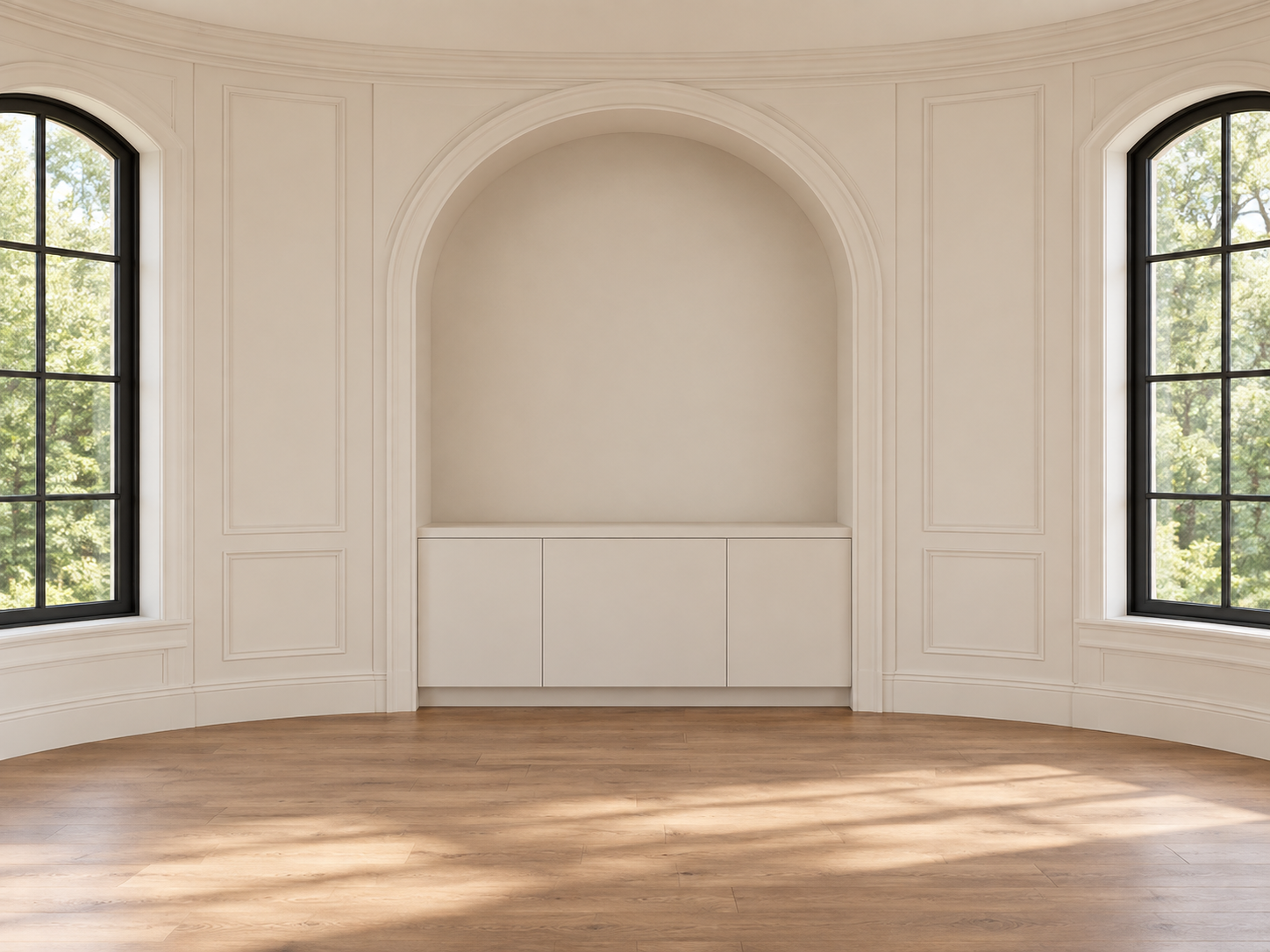 Warm ivory curved room with classical wall moulding, a central arched niche, black-framed windows, and natural oak flooring