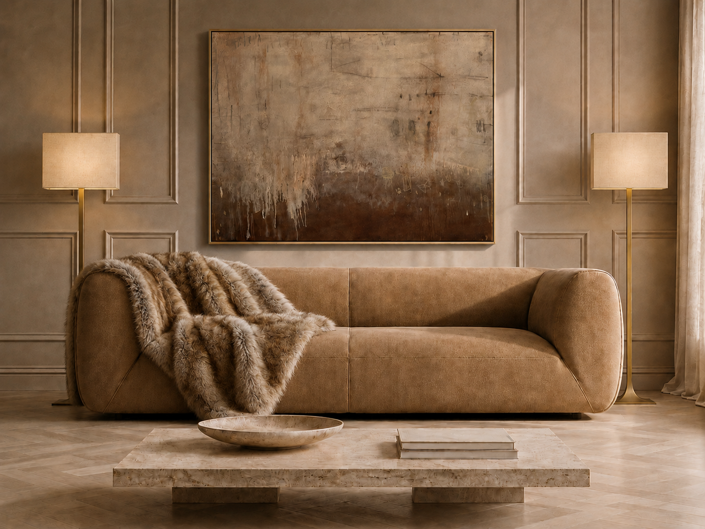 Styled living room with tan leather sofa, gold-framed artwork, brass floor lamps, and travertine coffee table on a herringbone floor