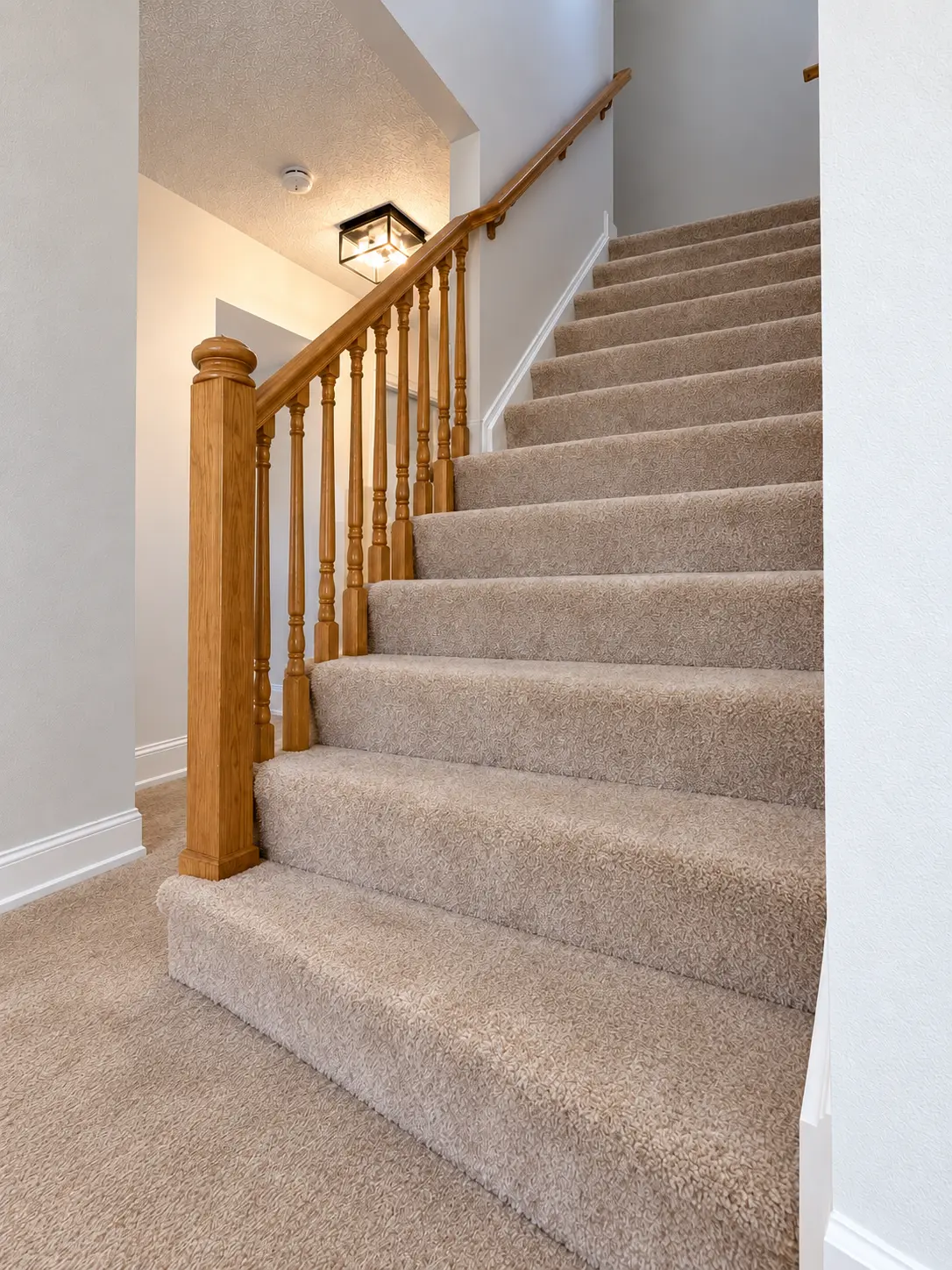 Carpeted staircase before Campbell's oak staircase build
